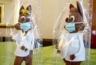 FILE PHOTO: Chocolate Easter bunnies holding syringes are displayed at Eric's Confiserie Baumann in Zurich