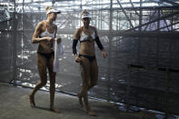 April Ross, right, of the United States, and teammate Alix Klineman prepare for a women's beach volleyball Gold Medal match against Australia at the 2020 Summer Olympics, Friday, Aug. 6, 2021, in Tokyo, Japan. (AP Photo/Felipe Dana)