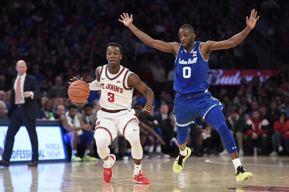 St. John's guard Rasheem Dunn (3) dribbles the ball as Seton Hall guard Quincy McKnight (0) defends during the second half of an NCAA college basketball game in New York, Saturday, Jan. 18, 2020. (AP Photo/Sarah Stier)