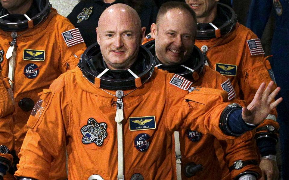  In this May 16, 2011, file photo, former NASA astronaut STS-134 commander Mark Kelly, front, waves a he leaves the Operations and Checkout Building with fellow crew members, including Mike Fincke, for a trip to Launch Pad 39-A, and a planned liftoff on the space shuttle Endeavour at Kennedy Space Center in Cape Canaveral, Fl - Chris O'Meara/AP