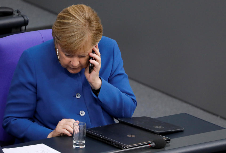 German Chancellor Angela Merkel speaks on the phone as she attends a session of Germany's lower house of parliament Bundestag in Berlin, Germany October 17, 2019 REUTERS/Michele Tantussi