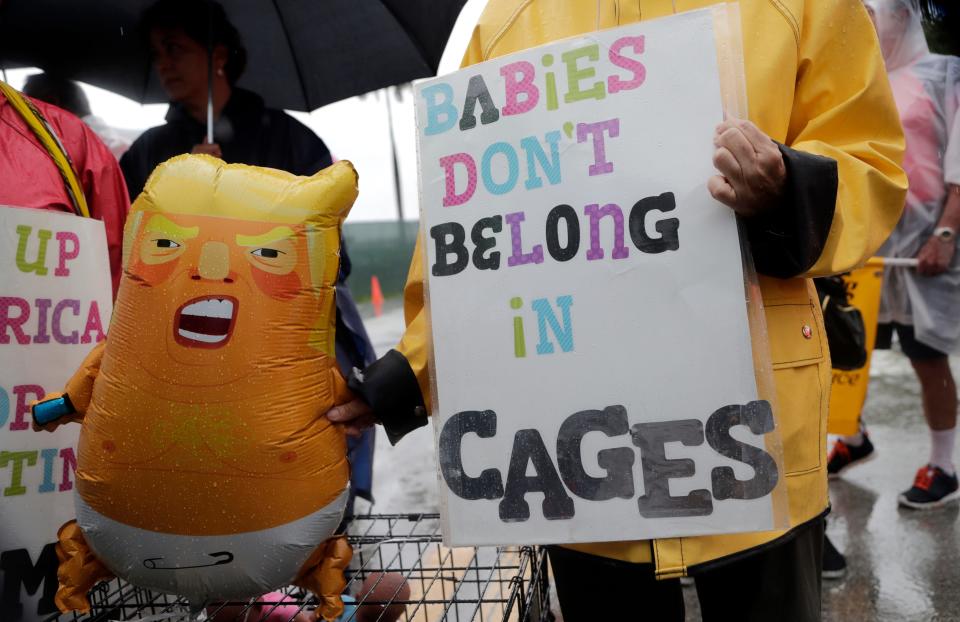Protesters hold an inflatable doll in the likeness of President Donald Trump outside of the Homestead Temporary Shelter for Unaccompanied Children, Sunday, June 16, 2019, in Homestead, Florida. A coalition of religious groups and immigrant advocates said they want the Homestead detention center closed. (AP Photo/Lynne Sladky)