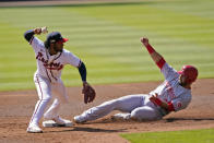 Atlanta Braves second baseman Ozzie Albies (1) throws to first after forcing out Cincinnati Reds' Eugenio Suarez (7) during the second inning in Game 2 of a National League wild-card baseball series, Thursday, Oct. 1, 2020, in Atlanta. The Reds' Mike Moustakas was safe at first. (AP Photo/John Bazemore)