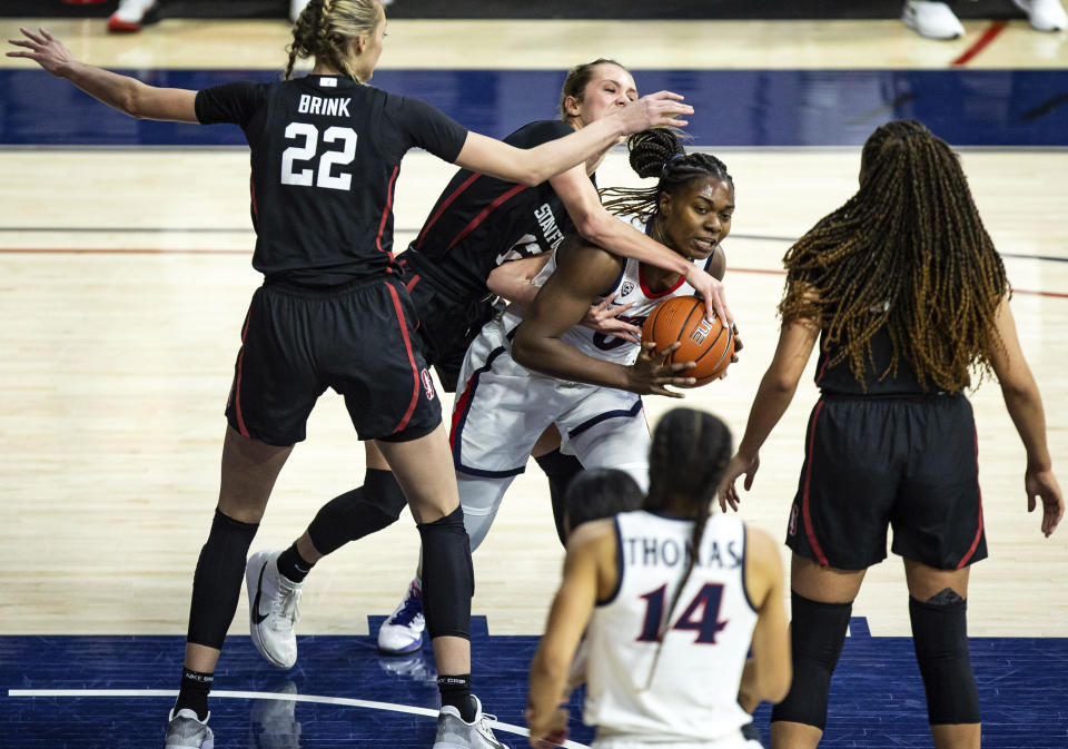 Arizona forward Trinity Baptiste (0) is defended by Stanford players during an NCAA college basketball game Friday, Jan. 1, 2021, in Tucson, Ariz. (Josh Galemore/Arizona Daily Star via AP)