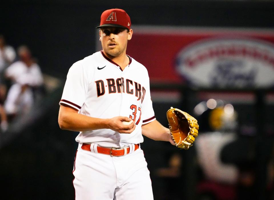 Arizona Diamondbacks relief pitcher Kevin Ginkel (37) reacts after giving up a 2-run double to Los Angeles Dodgers Cody Bellinger (35) in the seventh inning at Chase Field in Phoenix on Sept. 12, 2022.