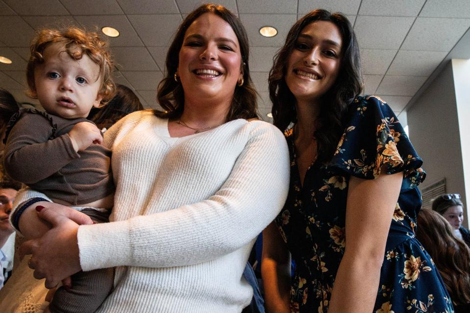 From left, Rabbi Avremel and Shulie Vogel's son, 1, and University of Delaware students Goldie Selig, a psychology major, and Gavi Newman, event co-chair and nursing major, attend the UD-hosted Mega Shabbat dinner at the Trabant University Center in Newark, Friday, Oct. 20, 2023.