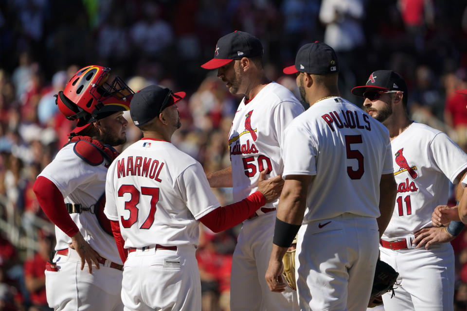 St. Louis Cardinals manager Oliver Marmol (37) talks with starting pitcher Adam Wainwright (50) as Marmol prepares to remove Wainwright along with catcher Yadier Molina, left, and first baseman Albert Pujols (5) at the same time during the fifth inning of a baseball game against the Pittsburgh Pirates Sunday, Oct. 2, 2022, in St. Louis. (AP Photo/Jeff Roberson)