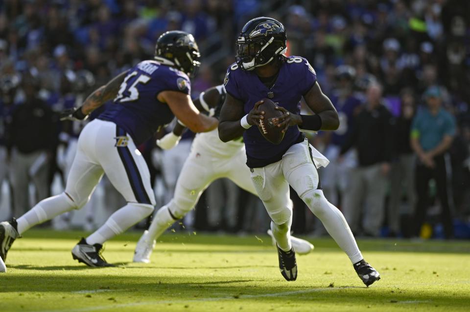 Nov 5, 2023; Baltimore, Maryland, USA; Baltimore Ravens quarterback Lamar Jackson (8) rolls out to pass during the first half against the Seattle Seahawks at M&T Bank Stadium. Mandatory Credit: Tommy Gilligan-USA TODAY Sports