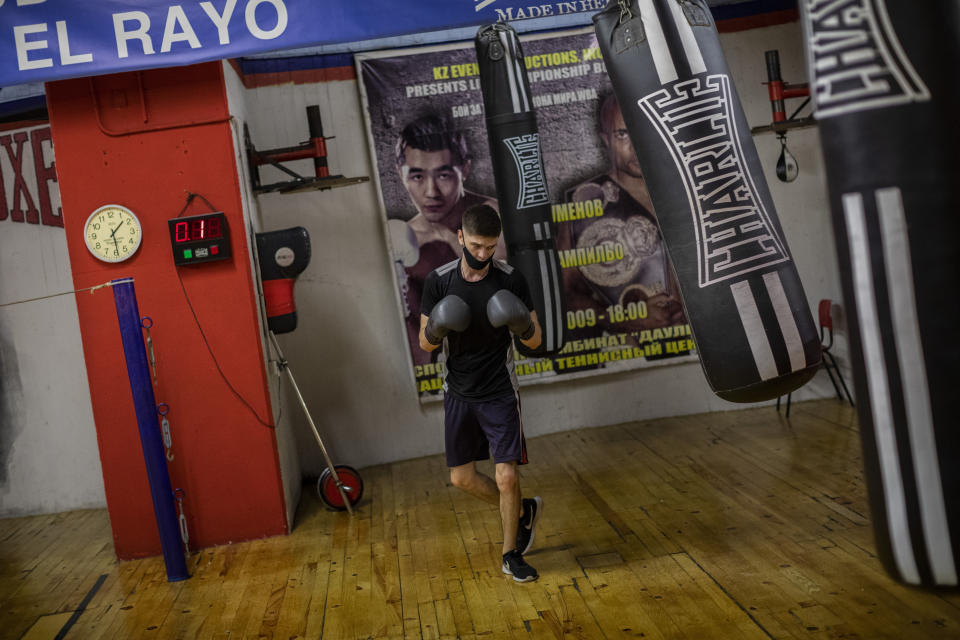 A man wearing face masks to prevent the spread of the coronavirus, exercises at a boxing gym in the southern neighbourhood of Vallecas in Madrid, Spain, Monday, Sept. 28, 2020. (AP Photo/Bernat Armangue)