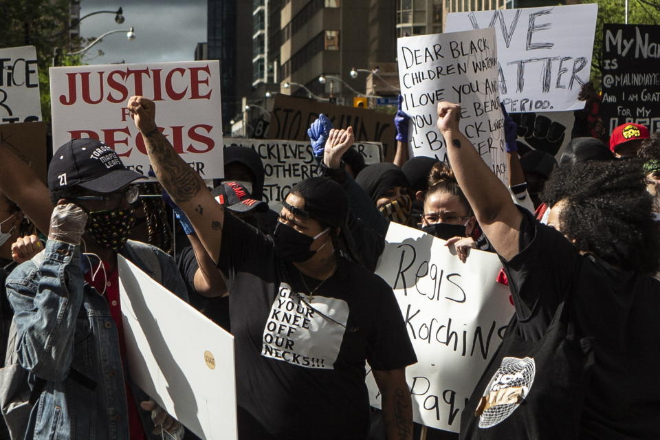 Demonstrators take part in a rally protesting the death of Regis Korchinski-Paquet in downtown Toronto, Saturday May 30, 2020. Korchinski-Paquet, 29, fell from the balcony of a 24th-floor Toronto apartment while police were in the home. Thousands of protesters took to the streets to rally in the aftermath of high-profile, police-involved deaths in both Canada and the United States. (Chris Young/The Canadian Press via AP)