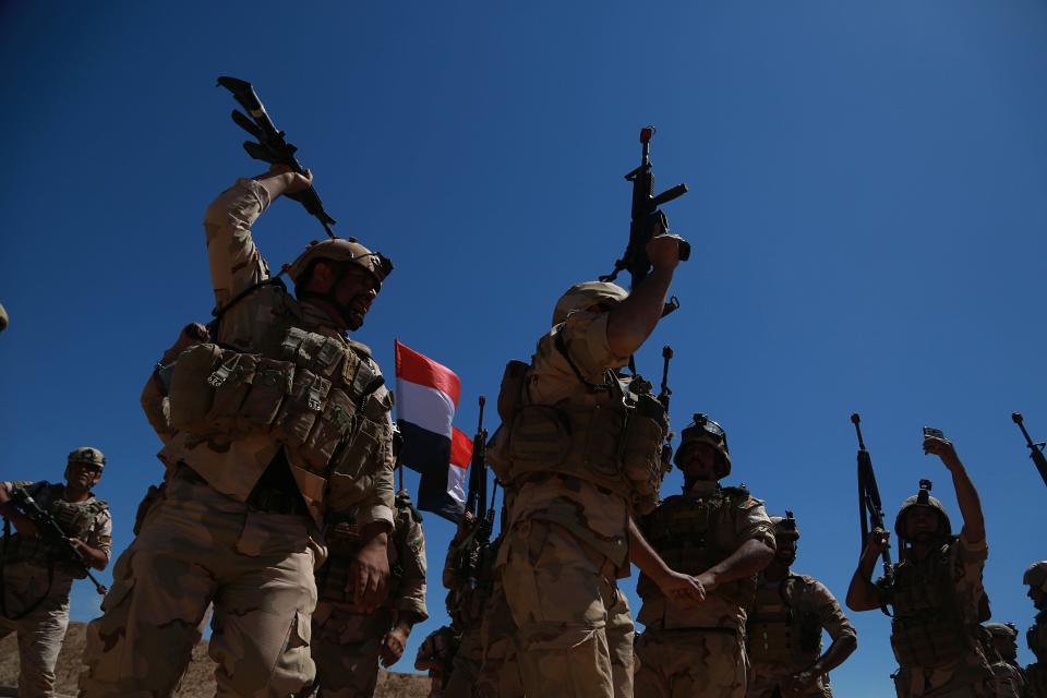 Iraqi soldiers chant slogans against IS while Australian and New Zealand coalition forces participate in a training mission with Iraqi army soldiers at Taji Base, north of Baghdad, Iraq, Wednesday, April 17, 2019. A month after the defeat of the Islamic State group in Syria and Iraq, the U.S.-led international coalition has turned its attention to training Iraqi forces to secure the country against lingering threats posed by IS cells operating in the countryside. (AP Photo/Hadi Mizban)