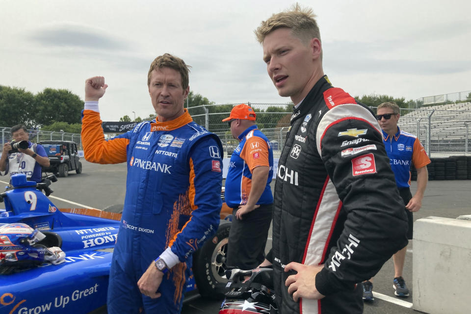 Six-time IndyCar champion Scott Dixon, left, chats with Josef Newgarden after they took a pace car lap at the IndyCar auto race, Friday, Aug. 6, 2021, in Nashville, Tenn. (AP Photo/Dan Gelston)