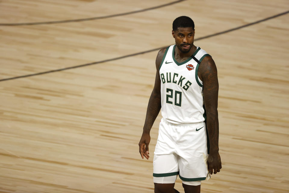 Milwaukee Bucks' Marvin Williams (20) looks on after a fight with Orlando Magic's James Ennis III (11) during Game 3 of an NBA basketball first-round playoff series, Saturday, Aug. 22, 2020, in Lake Buena Vista, Fla. (Mike Ehrmann/Pool Photo via AP)