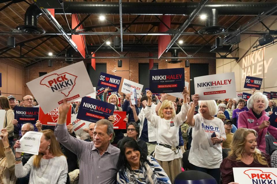Attendees of Nikki Haley's campaign event on Monday, Feb. 19, 2024, in Greer, including Greenville residents Jan Hubble, Ann Petrich and Joyce Murphy, wave campaign signs for Republican presidential candidate.