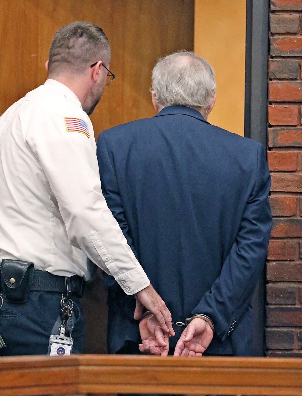 Norwell pediatrician Dr. Richard Kauff is taken from court after his arraignment in Hingham District Court on Monday, Nov. 20, 2023, on charges of sexual assault as a result of complaints from former patients.