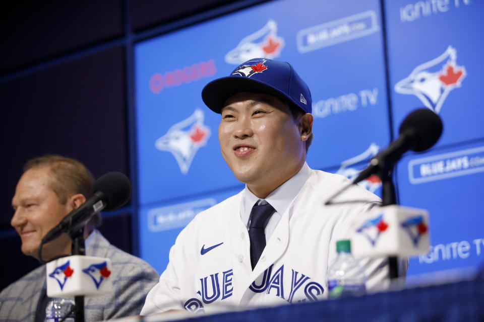 Toronto Blue Jays newly signed pitcher Hyun-Jin Ryu, right, smiles as he speaks to media at a news conference announcing his signing to the team in Toronto, Friday, Dec. 27, 2019. (Cole Burston/The Canadian Press via AP)