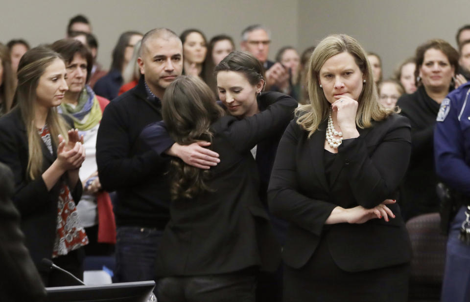 Former gymnast Rachael Denhollander, center, is hugged after giving her victim impact statement during the seventh day of Larry Nassar’s sentencing hearing. (AP)