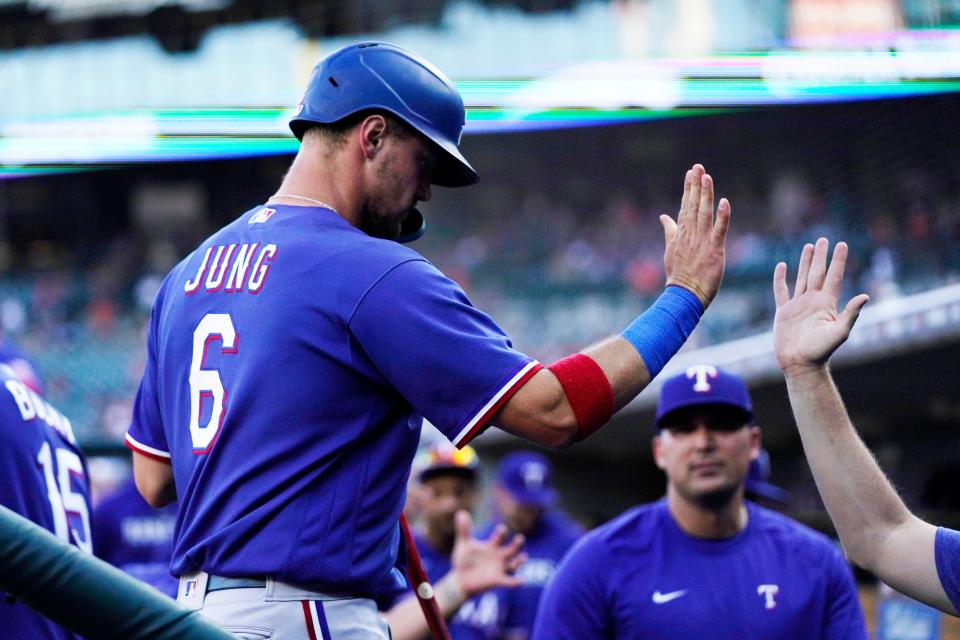 Texas Rangers' Josh Jung is greeted in the dugout after scoring from second on a double by Jonah Heim during the second inning of a game against the Detroit Tigers at Comerica Park in Detroit on Tuesday, May 30, 2023.