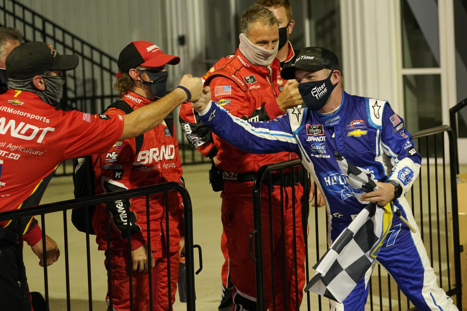 Justin Allgaier, right, greets his crew in Victory Lane as he celebrates after winning a NASCAR Xfinity Series auto race Friday, Sept. 11, 2020, in Richmond, Va. (AP Photo/Steve Helber)