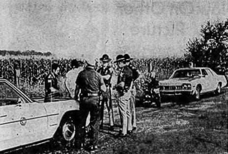 Detectives gather at the scene in August 1975, where three girls were assaulted in a cornfield on the east side of Indianapolis.