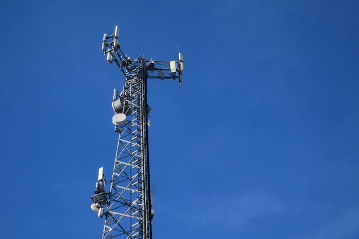 A cell tower with blue skies behind it