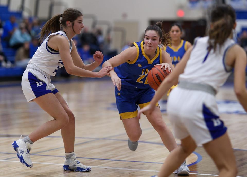 Ida's Kennedy Albring works toward the basket between Maddie Salenbien and Ellie Salenbien of Dundee during a 42-26 Dundee win earlier this season.