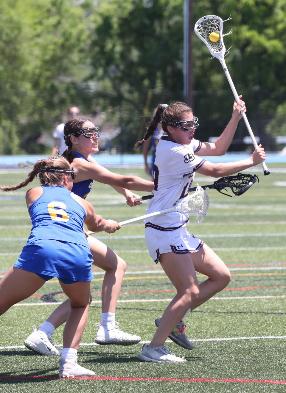 John Jay's Mia Puccio is defended by Queensbury defenders during their girls lacrosse Class B state regional final at Hendrick Hudson High School in Montrose, June 4, 2022. 