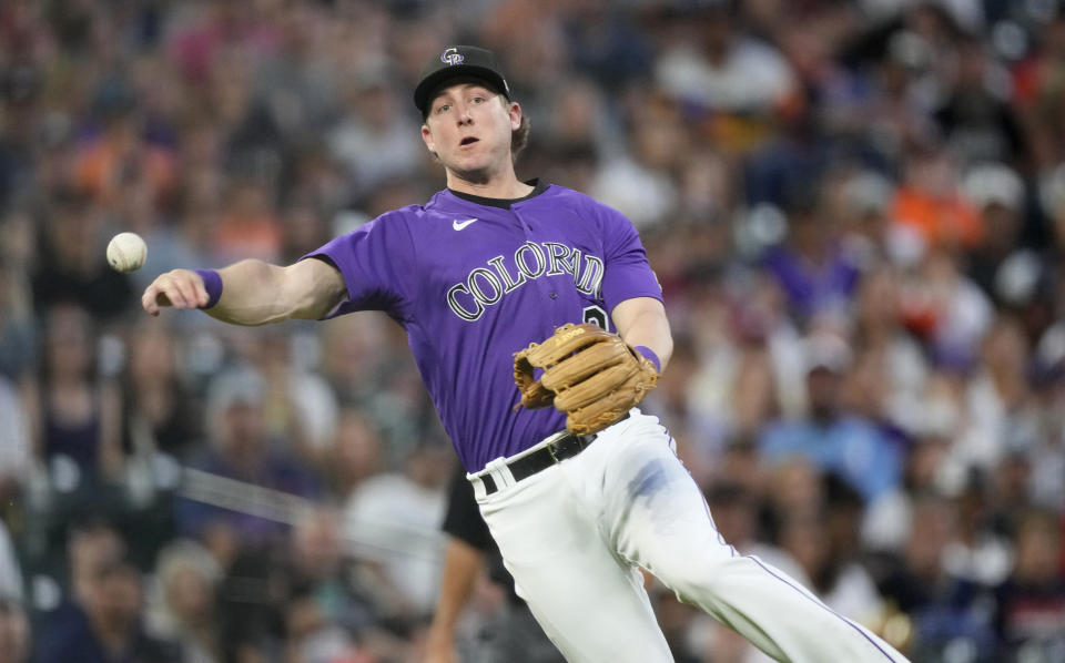 Colorado Rockies third baseman Ryan McMahon throws to first for the out on Houston Astros' Chas McCormick during the sixth inning of a baseball game Tuesday, July 18, 2023, in Denver. (AP Photo/David Zalubowski)