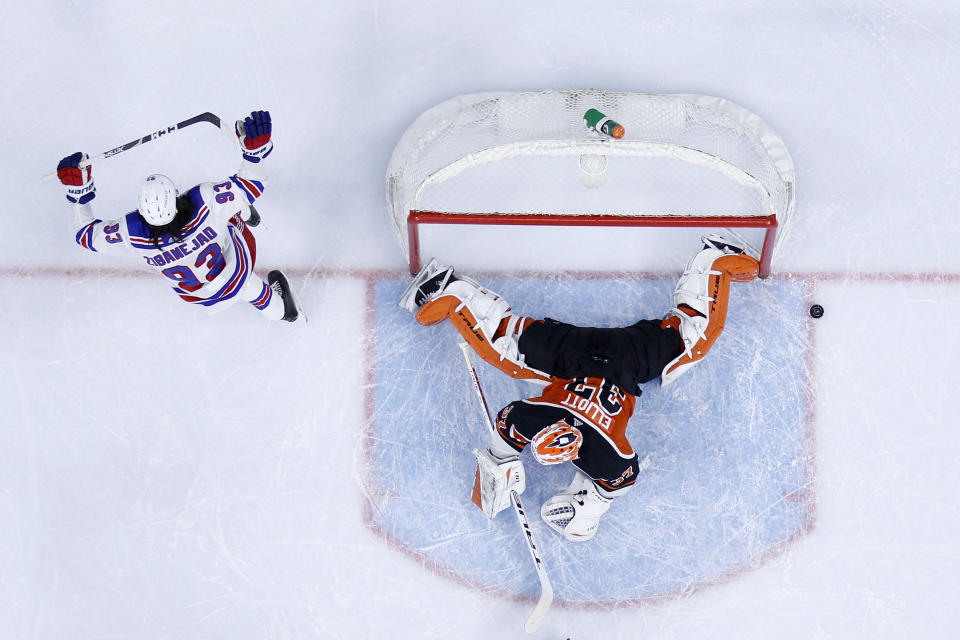 New York Rangers' Mika Zibanejad, left, celebrates after scoring a goal past Philadelphia Flyers goaltender Brian Elliott during the first period of an NHL hockey game, Saturday, March 27, 2021, in Philadelphia. (AP Photo/Derik Hamilton)