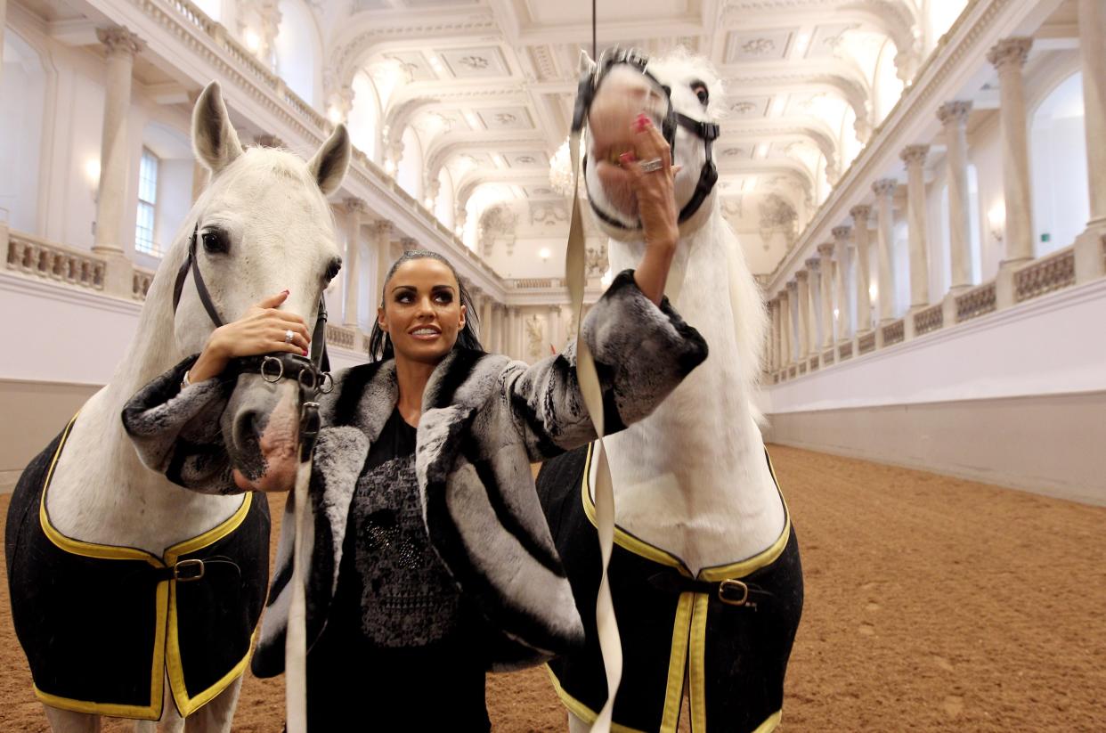 VIENNA, AUSTRIA - FEBRUARY 10:  (EXCLUSIVE ACCESS - PREMIUM RATES APPLY) Katie Price pets two horses inside the indoor riding arena at the Vienna Riding School on February 10, 2010 in Vienna, Austria.  (Photo by Miguel Villagran Acevedo/Getty Images)