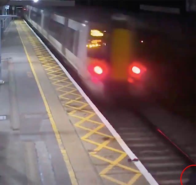 Acton can be partially seen (circled, bottom right) as he lies on the tracks. Source: BTP