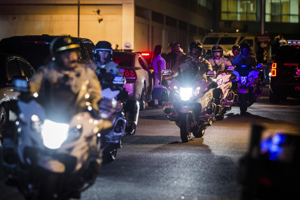 Motorcycle police officers escort the procession for fallen California Highway Patrol Officer Andre Moye at Riverside University Health System Medical Center in Moreno Valley on Monday, Aug 12, 2019. Moye was killed during a shootout following a traffic stop in Riverside. (Watchara Phomicinda/The Orange County Register via AP)