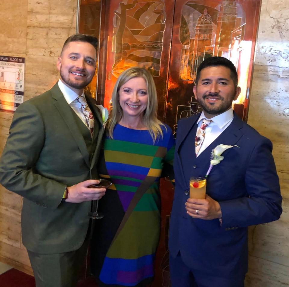 At The City Club of San Francisco on July 16, 2022, Social Butterfly columnist Kristi K. Higgins strikes a pose with newlyweds Ben Lecuona and Zac Eggers, her nephew, on the left.