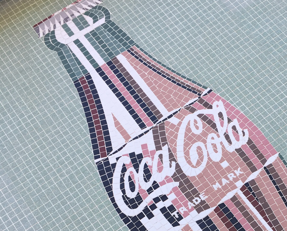 The mosaic illustration on the front of the old Coca-Cola building at 709 N. Augusta Street.