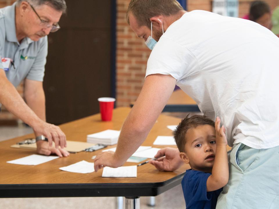 Josh Knight prepares to vote with his son, Eli, at South-Doyle High School during election day in Knoxville on Aug. 4.