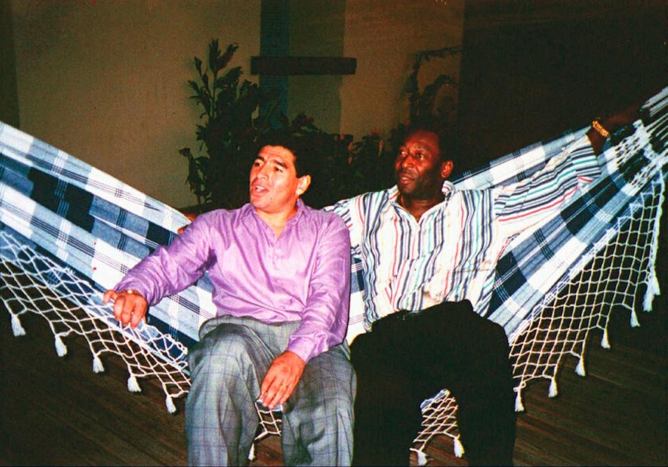 Diego Maradona, left, rests in a hammock with Pele during a meeting in Rio de Janeiro, Brazil, May 13, 1995. (AP)