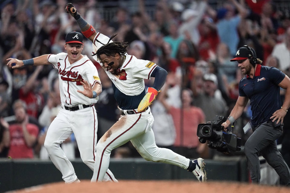 FILE - Atlanta Braves' Ronald Acuña Jr. celebrates after scoring the winning run on an Ozzie Albies base hit during the 10th inning of a baseball game against the Chicago Cubs, Wednesday, Sept. 27, 2023, in Atlanta. Atlanta's Ronald Acuña Jr. is favored to win the NL MVP award after becoming the first player with 40 home runs and 70 stolen bases in a season. (AP Photo/John Bazemore, File)