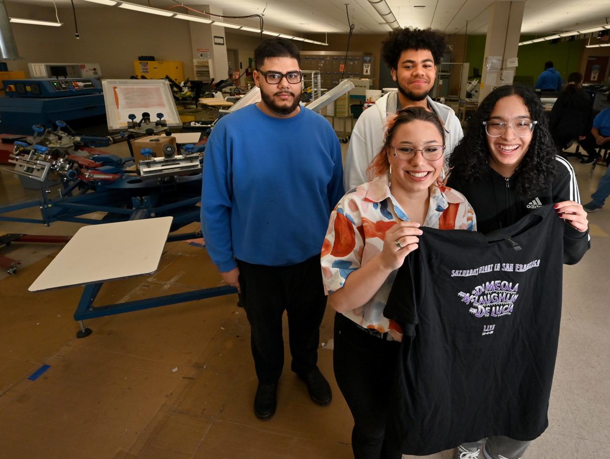 Worcester Tech students who helped print T-shirts for musician Al Di Meola: Jordan Marrero, Emily Rivera, Jayen Rojas and Javon Hargrove.