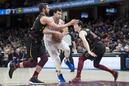 Mar 22, 2019; Cleveland, OH, USA; Los Angeles Clippers forward Danilo Gallinari (8) drives to the basket between Cleveland Cavaliers forward Kevin Love (0) and forward Cedi Osman (16) during the first half at Quicken Loans Arena. Mandatory Credit: Ken Blaze-USA TODAY Sports