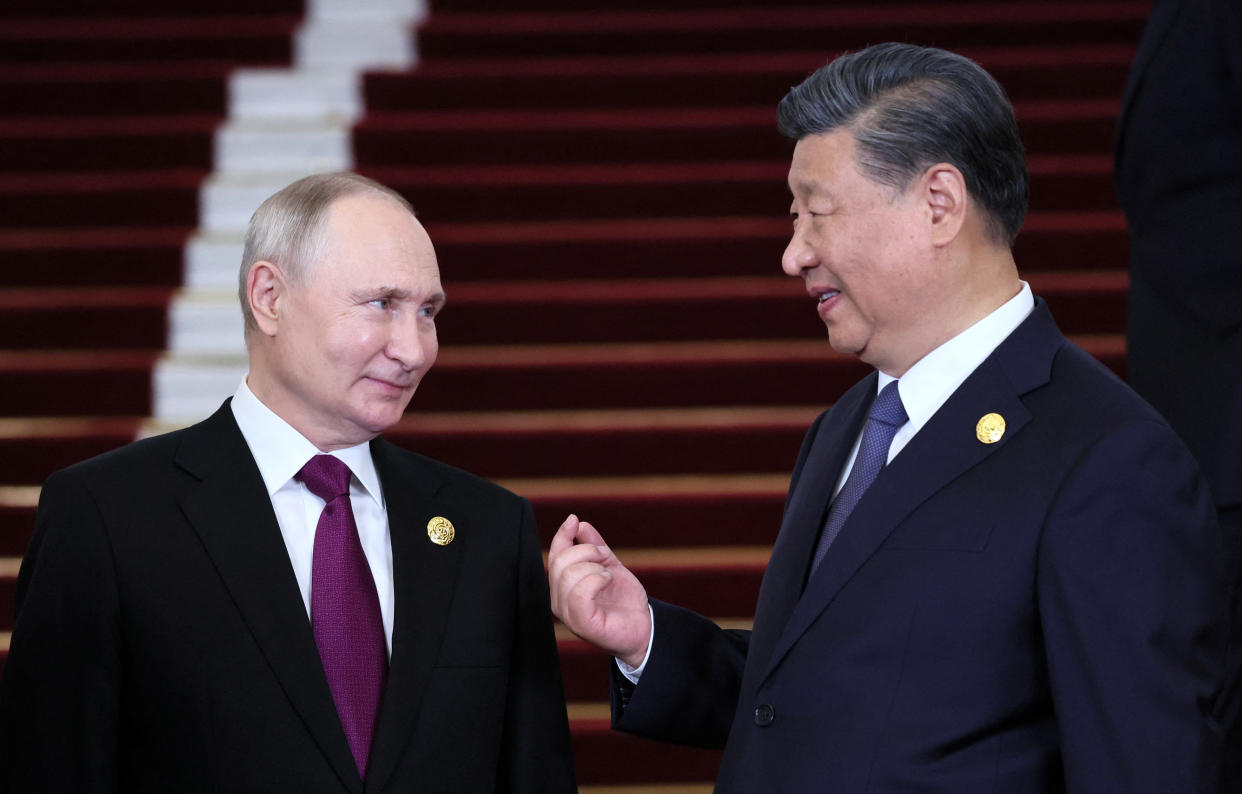 Russian President Vladimir Putin is welcomed by Chinese President Xi Jinping during a ceremony in Beijing on Oct. 17. 