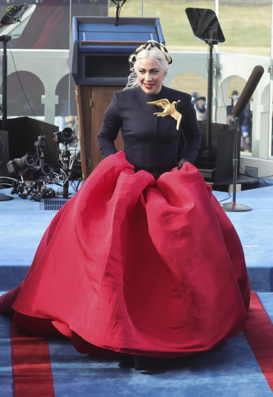 Lady Gaga picks up her skirt after singing the national anthem during the inauguration. (Photo: Pool via Getty Images)