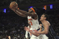 New York Knicks center Mitchell Robinson, left, rebounds over Dallas Mavericks center Dwight Powell, right, during the first quarter of an NBA basketball game, Saturday, Dec. 3, 2022, in New York. (AP Photo/Bebeto Matthews)