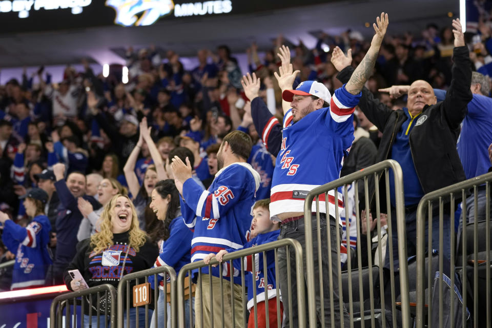 Fans celebrate after the New York Rangers scored a goal during the first period of the team's NHL hockey game against the Nashville Predators on Sunday, March 19, 2023, in New York. (AP Photo/Bryan Woolston)