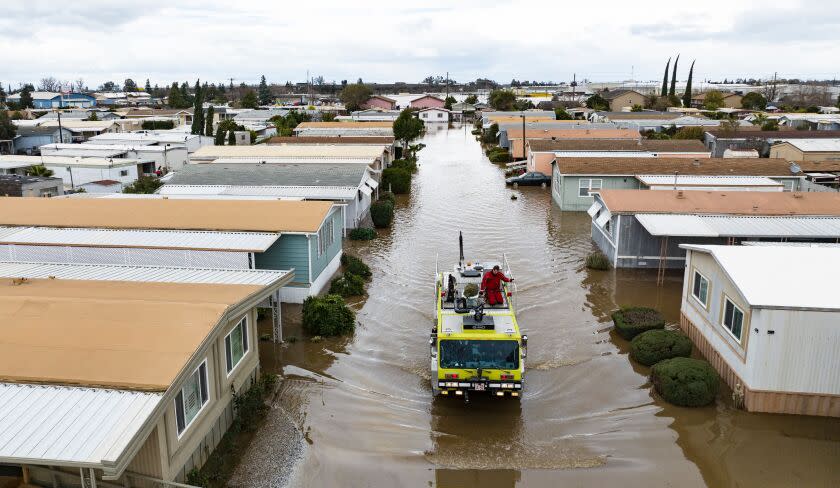 This aerial view shows rescue crews assisting stranded residents in a flooded neighborhood in Merced, California on January 10, 2023. - A massive storm called a bomb cyclone" by meteorologists has arrived and is expected to cause widespread flooding throughout the state. (Photo by JOSH EDELSON / AFP) (Photo by JOSH EDELSON/AFP via Getty Images)