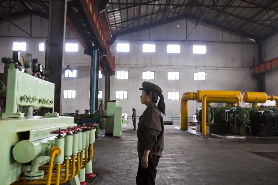 In this Aug. 10, 2012 photo, North Korean workers check the machinery at a fertilizer factory in Hamhung, North Korea's second largest city in South Hamgyong Province, North Korea. It has been a tough year for North Korea's farmers, who grappled with an extended dry spell in the spring, followed by heavy rains from a series of summer storms and typhoon. The U.N. is launching a field mission across North Korea to gauge the state of the food situation. (AP Photo/David Guttenfelder)