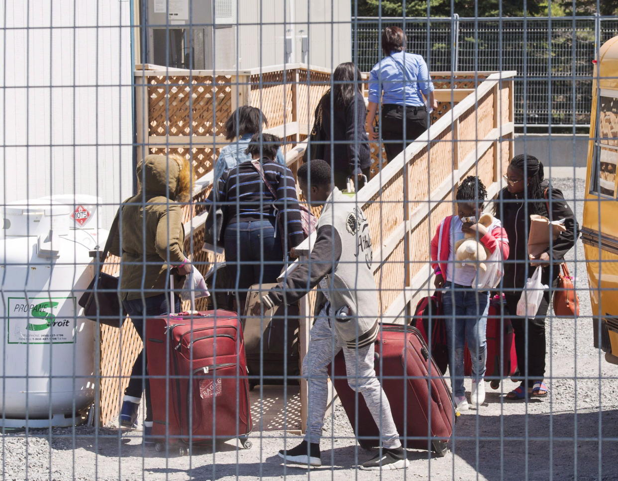 A group of asylum seekers arrive at the temporary housing facilities at the border crossing on May 9, 2018, in St. Bernard-de-Lacolle, Que. Photo from The Canadian Press.