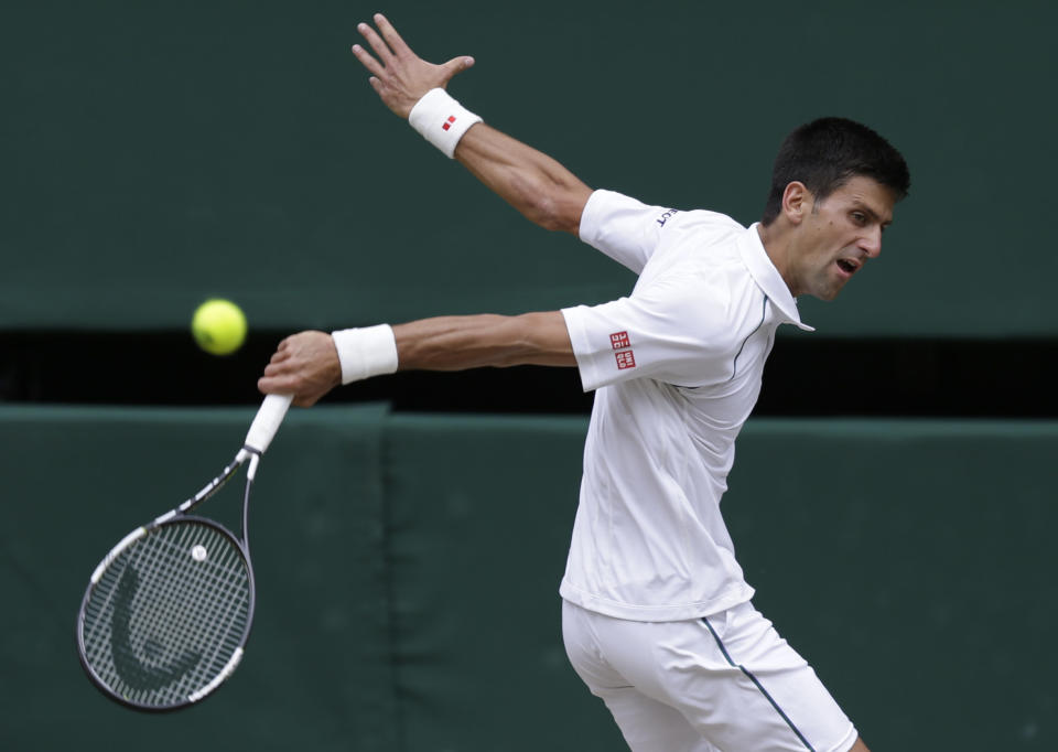 Novak Djokovic of Serbia returns a ball to Roger Federer of Switzerland during the men's singles final at the All England Lawn Tennis Championships in Wimbledon, London, Sunday July 12, 2015. (AP Photo/Pavel Golovkin)