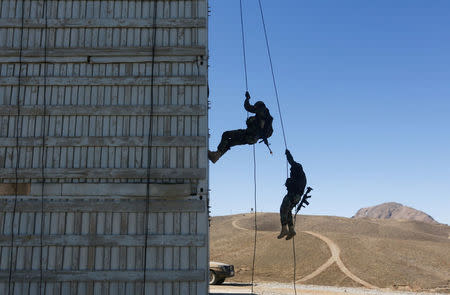 Afghan army Special Forces take part in a military exercise in Rishkhur district outside Kabul, Afghanistan February 25, 2017. Picture taken on February 25, 2017. REUTERS/Omar Sobhani