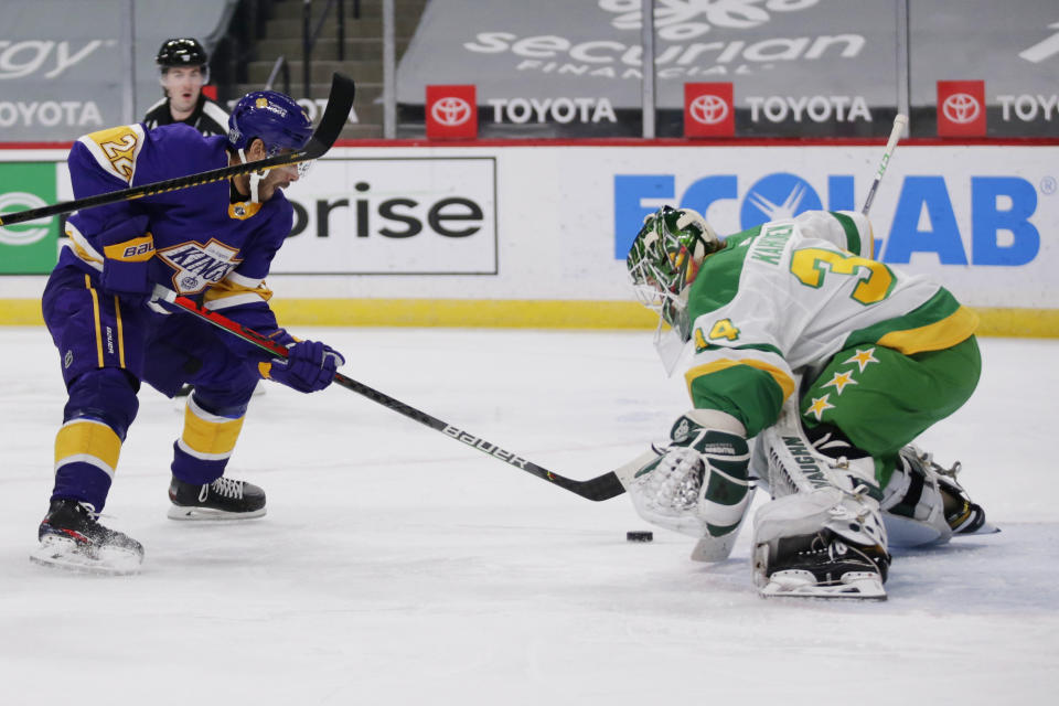 Los Angeles Kings left wing Andreas Athanasiou (22) is stopped by Minnesota Wild goaltender Kaapo Kahkonen (34) in the first period during an NHL hockey game, Saturday, Feb. 27, 2021, in St. Paul, Minn. (AP Photo/Andy Clayton-King)