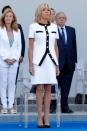 <p>In a white button-up sweater and matching skirt for the Bastille Day military parade. </p>